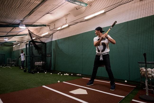 Tom Brady, who was at Fenway Park on Opening Day 2015 to throw out a ceremonial first pitch, takes BP with former Red Sox ace Pedro Martinez before the game.